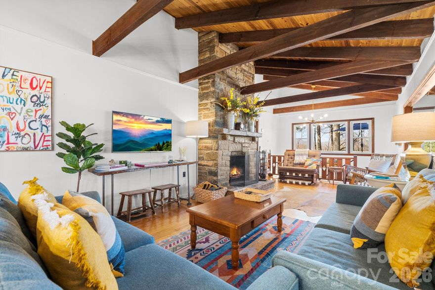 This well-maintained midcentury style mountain cottage offers a beautiful balance of cozy charm and functional living space.
Step inside to a thoughtfully furnished living room, featuring vaulted ceilings and a floor-to-ceiling stone fireplace. The living room connects seamlessly to a dining area that then flows into a well-equipped kitchen, creating an easy layout for everyday living and entertaining.
The main level includes two bedrooms, each with plentiful closet space, and a full bathroom. Completing the main floor is a bright sunroom that opens to a spacious deck overlooking the double lot, with Grandfather Mountain and Hanging Rock views!
The lower level adds flexibility with additional sleeping space, a second living area, a full bath, a half bath, laundry area, and access to a smaller covered deck that invites you to come out and sit on the porch swing for a while.  The firepit in the side yard with adirondack chairs is an equally inviting scene - sit and roast some marshmallows or just take in the fresh mountain air!  An attached carport and multiple parking areas round off the outdoor space and offer added convenience for hosting or even just bringing in the groceries.
The gated community of Crystal Mountain is a hidden gem for those seeking a small neighborhood feel. Adventure Awaits: You are minutes from the Blue Ridge Parkway, hiking around Bass or Trout Lake, and world-class dining like The Gamekeeper. Whether you are looking for a full-time residence or a short-term rental, this community delivers the peace of the woods with the convenience of being either 20 minutes to Boone or 10 minutes to downtown Blowing Rock. Offered mostly furnished, this property is ready for your immediate enjoyment! Don’t miss this rare opportunity to own in a location that's second to none.