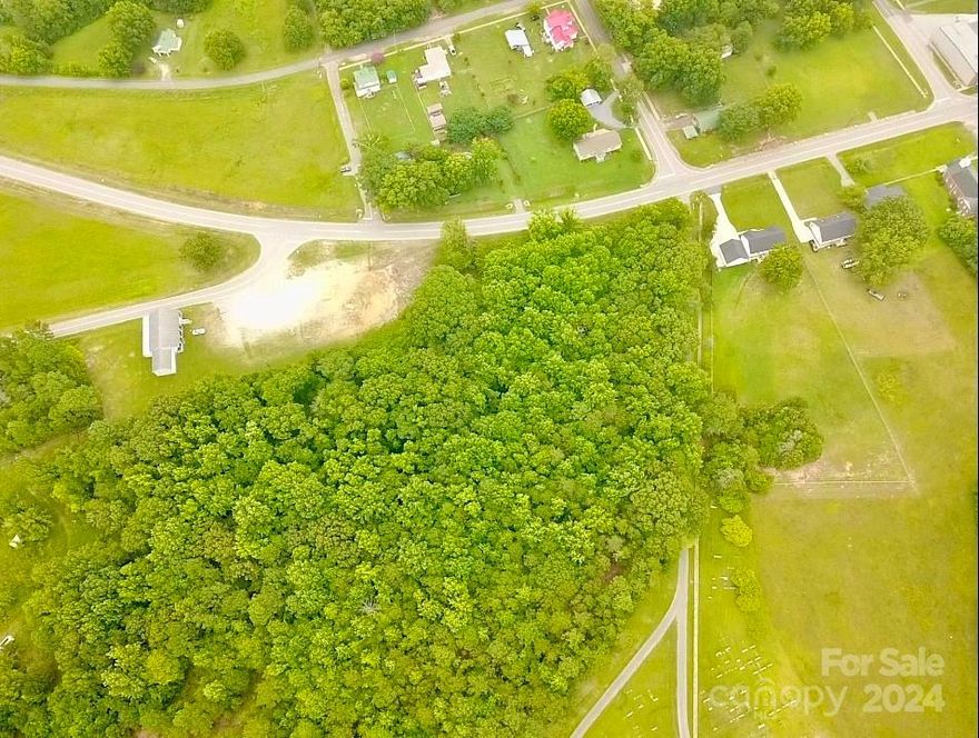 Escape to tranquil Hickory Grove with this exceptional forested property. Nestled within the idyllic surroundings, this 7.5 +/- acre property offers the perfect opportunity to plant your roots in a small town setting. With its abundant natural beauty including large hardwoods, native fauna and flora, this property is a haven for nature enthusiasts and outdoor lovers looking for privacy without sacrificing a convenient location. 4 BR Septic permit on file. Water available through town of Hickory Grove. Manufactured homes allowed.  Property fronts Wylie Avenue only. There is a small strip of land between Cemetery Street and the property that removes any road frontage for same. Limited deed restrictions to convey. Can be subdivided at buyers expense.