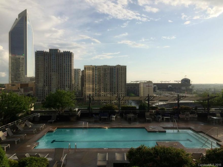 Immaculate condo in the heart of Uptown with many exceptional builder upgrades, including natural color hardwoods throughout bedroom and living areas, custom closet design in master closet, mission style cabinetry in kitchen and bath, convection range and french-door fridge as well as a full-size bathtub.  Incredible sunset views from balcony overlooking Trademark amenities deck/pool, Knight's ballpark, Panthers’ stadium and Bearden park!  Easy walk to all Uptown amenities/attractions!