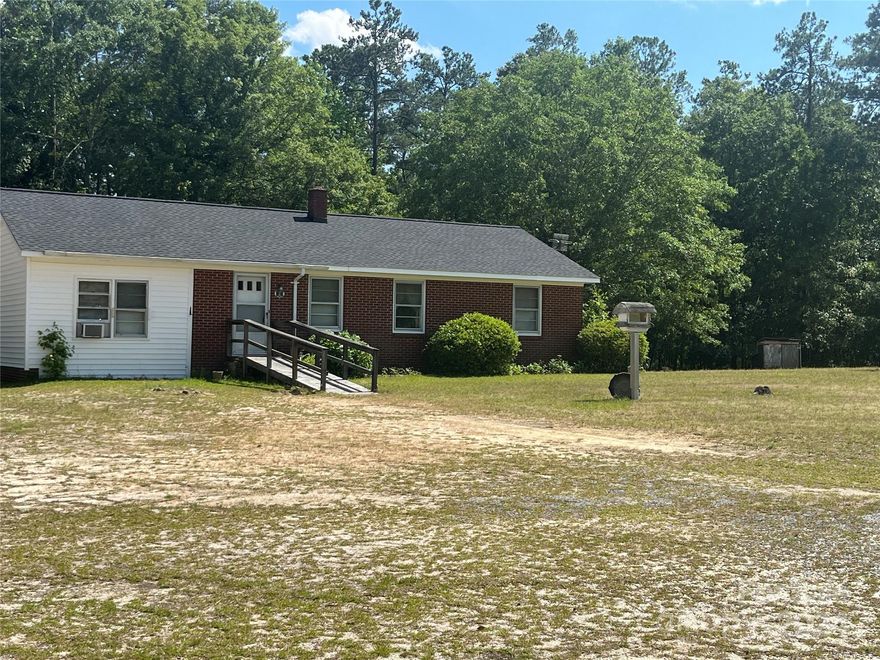 A charming three-bedroom brick home sits on a spacious one-acre lot. This older residence exudes character and classic appeal, featuring solid brick construction that provides durability and timeless aesthetics. The expansive lot offers outdoor space, perfect for gardening, recreational activities, or potential expansion. Inside, the home retains many original features that add to its unique charm. This is ideal for those seeking a blend of vintage appeal and ample outdoor living space. This home needs some updating but would make the perfect home! The garage area on the home has been enclosed and a new roof was just placed. The separate garage does not go with the home.