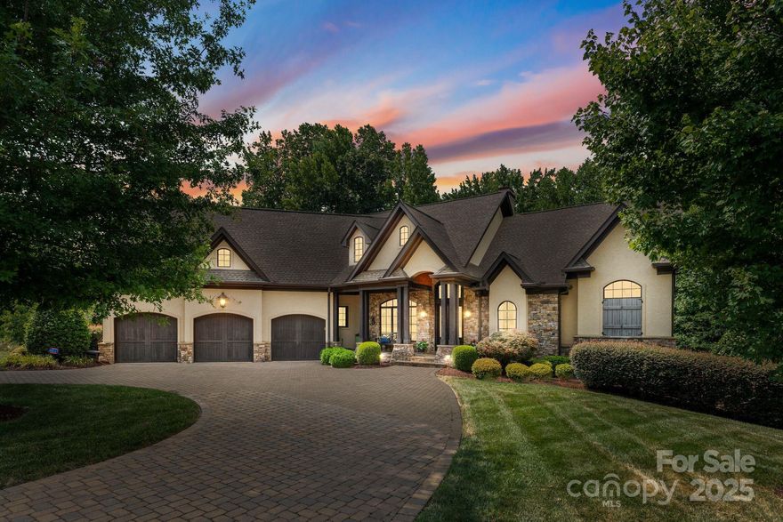 Step into luxury with this meticulously designed French country-style home in a prestigious gated community. A paver circular drive way will bring you right to the 3 car garage. Notice the hand chiseled stacked stone accents on the exterior & interior as you step into the open floor-plan with a spacious dining room, office, & cozy living room that features exposed beams & a cozy stone fireplace. The chef’s kitchen boasts Thermador appliances, double ovens, custom cabinetry, rounded breakfast nook overlooking the family room with a built-in fireplace—perfect for entertaining. Enjoy year-round outdoor living with a covered porch, gas grill, & fireplace. The spacious primary bedroom has soaring double trey 13-ft ceilings, with a designer bathroom featuring heated floors & custom closets. Elegant chandeliers fill this home with warm light. Oversized windows pour in natural light throughout all living areas. Smart home technology gives you sound & lighting controls at the tap of a finger.