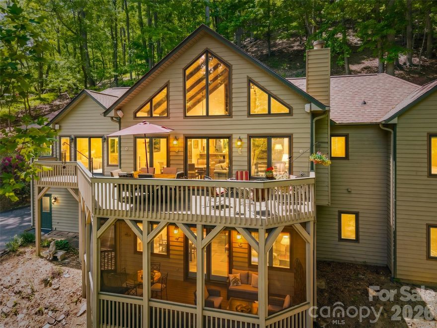 Perched within the tranquil, gated community of High Vista, this 3,055 SF Mountain home offers a seamless blend of Natural Beauty and Everyday Modern Functionality.
Enter through the light-filled Foyer to find Dramatic Vaulted Wood Ceilings and a Unique Staircase with Custom Rhododendron Branch Balusters— complemented by a matching chandelier—an immediate statement of the home’s Unique Features and Character. Recently refinished Oak Hardwood Floors continue throughout, leading into an Open-Concept Living, Dining, and Kitchen area with bar seating.
The main level lives like a ranch with a Split-3 Bedroom floor plan. A warm and inviting Family Room, anchored by a Stone Surrounded Gas Fireplace with built-in Bookshelves, creates a cozy gathering space. The Primary Suite features a sitting area, his-and-hers closets, windows overlooking the mountains, direct access to the upper deck, and an en-suite bath with dual vanities, a garden tub, and a walk-in shower. Two additional Bedrooms, a Full Bath with an updated walk-in shower, and a Laundry room complete the main level.
The Fully Finished Lower Level offers exceptional flexibility with a large Gathering Room, two additional Flex Rooms suitable for guests or office space, and a wellness/fitness space featuring a sauna.
Outdoor living is equally inviting. Enjoy seasonal mountain views from the elevated upper deck or unwind on the lower-level screened porch. A slate walkway leads to the front entrance, where a quiet sitting area and beautifully landscaped gardens provide a welcoming first impression.
Recent updates include refinished Oak Hardwoods, HVAC system (2023), Roof (2021), Appliances, and a Tankless propane Water heater.  Membership in the High Vista Amenities Association (POA) is conveyed with the home, providing access to the pool, tennis/pickleball courts, a neighborhood pub, and a vibrant calendar of social events. Optional membership to the Chestnut Mountain Golf Club is also available.
Conveniently located less than 10 minutes from shopping, dining, the airport, and local breweries—this home offers the perfect balance of privacy, community, and accessibility.