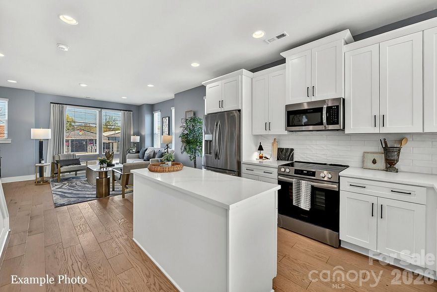 WOW! ROOFTOP TERRACE WITH CITY VIEWS, COMMUNITY DOG PARK AND CLOSE PROXIMITY TO UPTOWN BELOW $450K! Receive up to $13,000 towards closing costs and/or lowering the interest rate with our preferred lender! PREMIUM LOCATION JUST 2 BLOCKS TO CAMP NORTH END, LIVE IN A NEW, BEAUTIFULLY APPOINTED TOWNHOME! Discover Modern Industrial Living at "North End Terraces". A Unique Townhome Community of 69 Homes w/ Modern Design and Artful Architecture. Nestled between Charlotte's thriving Arts District, NODA, and the bustling Central Business District of Uptown. 

3 bedrooms, 2 full/2 half baths, 2 car attached garage WITH EV CHARGER. Upscale finishes including blonde LVP floors throughout main living area and upstairs hallway, plus oak tread staircases leading to main & second floors. Designer kitchen with white cabinets, quartz countertops, mist glossy watercolor backsplash, stainless steel appliances including range, dishwasher & microwave. Primary bath features a large, tiled walk-in-shower with basket weave tile wet-bed, modern black fixtures, tiled floors in all full baths and more! This home is not to be missed!

INVESTORS:NO RENTAL RESTRICTIONS.