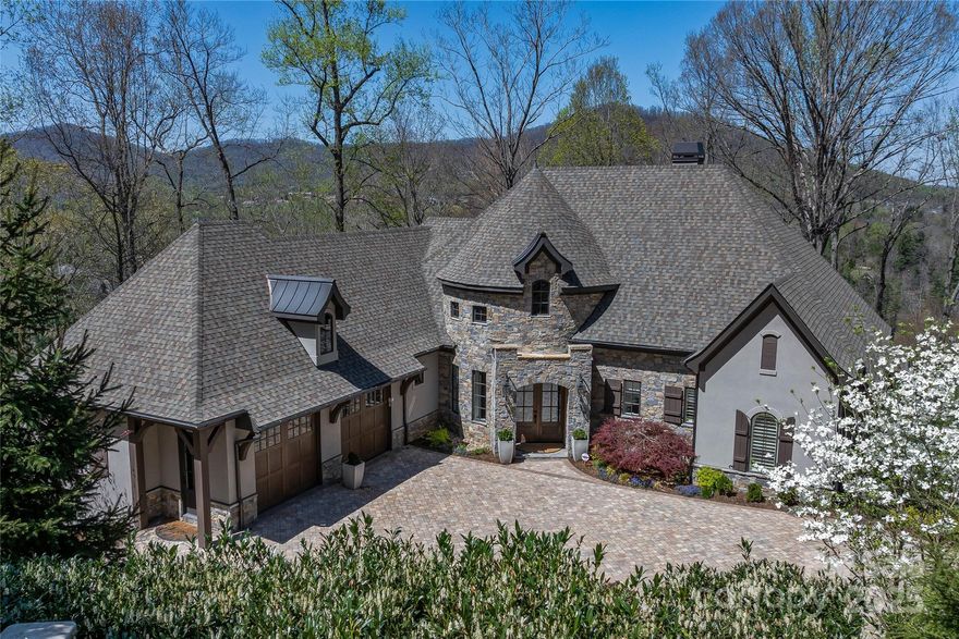 This impeccable mountain transitional home within the gates of The Cliffs at Walnut Cove is the epitome of comfortable luxury living.  The custom home completed in 2019 sits on 2.4 acres and allows excellent privacy.  The gentle paver drive opens to a generous auto court.  Upon entry you are welcomed with an open floor plan. The great room with cathedral ceiling flows seamlessly into the chef’s kitchen and dining space.  The custom touches of stonework and beams, the wood paneled coffered ceiling in the kitchen, and wet bar make for a very comfortable space. The kitchen was thoughtfully designed with a hidden pantry, a large island and appointed with Thermador appliances. The curved stair case leads down to the lower level club room and guest bedrooms. The space is ideal for gaming and entertaining with surround sound media. Walnut Cove is home to a Signature Jack Nicklaus course and one of 7 club communities in The Cliffs. A club membership is available for purchase at close.