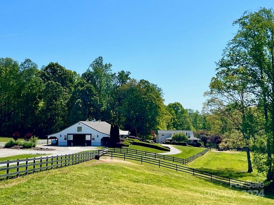 Luxury equestrian estate has it all. Private & tranquil location w/ gated entrance, high-end custom main barn w/ 15 matted stalls, auto water, gorgeous tongue & groove walls, huge tack room, feed room, climate controlled lounge/kitchenette, office, and full bath. Wash stall, 2 cross ties, auto fly system both barns, fans, riding trails, pond, lovely landscaping.  2nd barn has (3) 10x20 matted stalls, tack & feed rooms,cross tie, 10 turnouts, mud control, 3 run-ins, hay/shavings building, 175x72 Morton covered riding arena w/ fiber footing, outdoor jump arena, detached 3-car garage w/ unfinished upper level (could be finished for a trainer's apartment). Too much to list here. Would also make a gorgeous wedding venue w/ stunning sunrises and sunsets. 45 min. to airport.  Residence recently remodeled w/ new cabinets, quartz counters, primary bath updated w/ freestanding tub, custom tiled shower, LVP flooring throughout, neutral paint, 4 BR/3 BA + huge bonus room, open w/ vaulted ceiling.