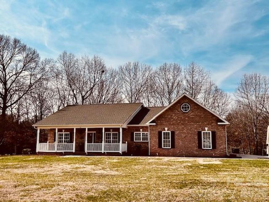 Picturesque 3 acre setting for this beautiful brick home with lots of living space and a split BR floor plan.  
Enter from the gorgeous front porch into the Foyer.   You will be met with gleaming hardwood floors which are found throughout most of the home.   Proceed into the Den with built-in enclosed bookcase & gas log FP.  The Den is open to the large kitchen offering lots of granite counter space, lovely oak cabinets and a roomy breakfast area.   Entrance to formal DR is flanked by gracious columns and the DR offers built-in corner china cabinets.   A Florida room (enclosed porch) at the rear of the home features tile flooring, huge windows, wood ceiling and overlooks your beautiful back yard.  (This space is heated and cooled by a mini-split system, and is an additional 280 sq feet of space that is NOT included in the heated square footage above as a permit could not be found, but is noted in 'other sq ft' )   An adjoining sunroom has tile floors, lots of windows, skylights and is also accessible to the Primary BR.  The Primary BR has a gas log FP and tv nook.  The large primary bath offers tiled floors, walk-in shower, large granite topped vanity and dressing table, and a skylight for lovely natural light.  A spacious walk-in closet completes the Primary BR wing.  Two additional BRs and a full bath are located at the other end of the home.  A laundry room with storage closet and sink opens to the double garage.   Outside you will find the dream spot for any handyperson or hobbyist - a 24 x 36 building with 10' ceilings, garage door, Pulldown stairs to attic, deep sink and woodstove - excellent building for storage or hobbies.  A detached carport and another storage building provide even more extra space.