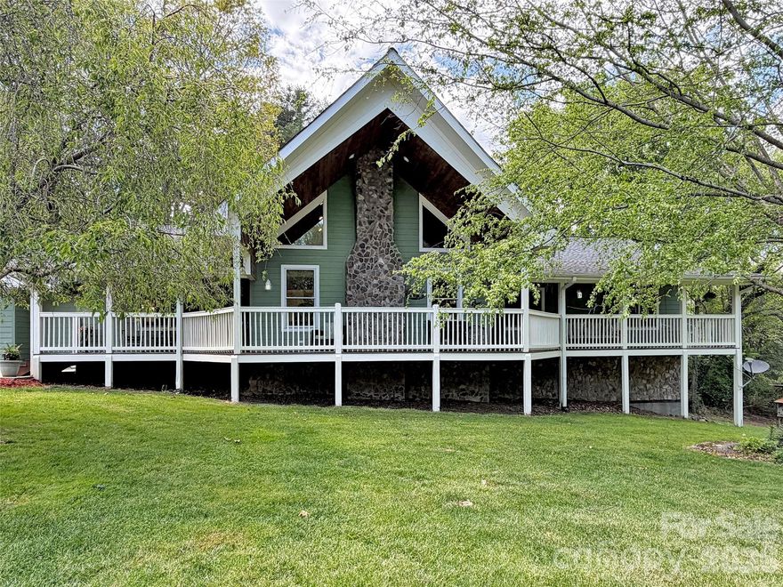 Welcome home to this inviting 4-bedroom, 2-bath residence sited on 1.09 unrestricted acres, offering room to breathe, garden, and play while still enjoying easy year-round access. The open floor plan features a light-filled great room with a cathedral ceiling that flows seamlessly into the kitchen and dining area, creating an ideal space for both everyday living and entertaining, and an airy loft that is perfect for a home office or cozy reading nook with lots of natural light. A true main-level living layout means you can do all of your daily life on one level, with a desirable split floor plan that provides privacy between the spacious primary suite and the guest bedrooms. The primary suite offers generous proportions, a walk-in closet, and an en-suite bath, giving you a comfortable retreat at the end of the day. A full unfinished basement, already stubbed for an additional bath, provides incredible potential for future expansion—envision a family room, hobby space, home gym, or additional guest quarters. Car enthusiasts, hobbyists, or anyone needing storage will appreciate the oversized main-level 2-car garage plus an additional 1-car garage in the basement, offering abundant space for vehicles, tools, outdoor gear, and seasonal décor. Spectrum high-speed internet makes streaming, gaming, and remote work a breeze, a true bonus in the mountains. The unrestricted acreage offers flexibility for pets, parking, fire pit, garden, or a small workshop. Ideally located approximately 10 minutes to Main Street Waynesville for dining, shopping, breweries, and local events, and within easy reach of the Great Smoky Mountains National Park, this home is a fantastic base for outdoor adventures. You are also about a 30-minute drive to Asheville’s vibrant arts and food scene or to Western Carolina University, making this property well positioned for work, school, and play. With its functional floor plan, expansion potential, and convenient mountain location, this property is ready for you to make it your next home.