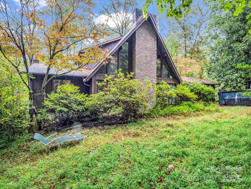 Drive to the end of Chickadee Lane and you'll find a wooded lot in a serene, sought-after neighborhood. This rare 1970s home in Illahee Hills is a preserved masterpiece of its era. Inside, an open-concept floor plan showcases vaulted ceilings, stunning natural wood paneling, an a stone fireplace at its heart. The flow is designed for convivial living and effortless entertaining. Expansive floor-to-ceiling windows connect the interior with the surrounding nature, creating a peaceful, secluded retreat. Enjoy the best of retro design with the unparalleled privacy and prestige of an irreplaceable address. With its enviable location and a layout that was ahead of its time, this property offers a chance to build significant equity by adding your personal touch and style.