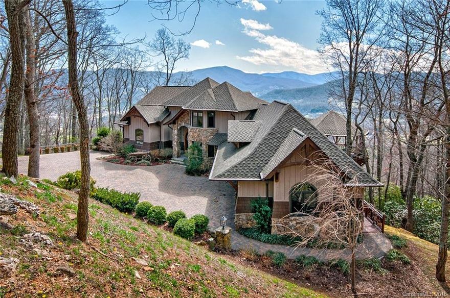 Grand Mountain Craftsman Style Timber Frame Home with magnificent sweeping views of the surrounding mountains and valleys!!  This elegant quintessential North Carolina mountain home welcomes you with soaring ceilings and a masterpiece stone fireplace, large open gourmet kitchen opening to expansive decks and an intimate outdoor gathering porch with another fireplace.  Come home to North Carolina Mountain Living at it's finest!  Home has a three story elevator and four bedrooms!