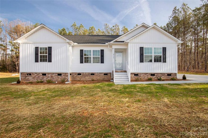 This new construction home in Kershaw is situated on 1.86 acres and has the most captivating curb appeal.  You'll walk into an open living/dining area with alleyway kitchen that features granite counter tops and all stainless steel appliances.  You'll also notice the oversized primary suite with a walk in closet, double vanities and walk in shower.  All bedrooms in this home have walk in closets.  You'll also love the recessed lighting and crown molding in the main living areas,   & the large laundry room with shelving.  Enjoy the private back deck and the flat yard.  There's an additional driveway should you want to build a shop/building.  This home offers country living with town right around the corner!