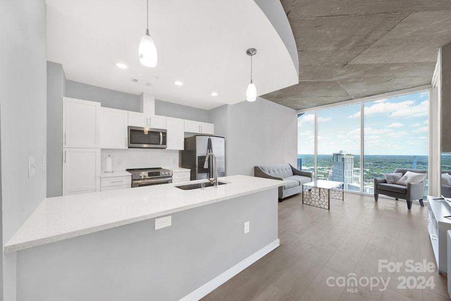 Experience absolute luxury and urban living at its finest in this completely updated 1 bedroom, 1 bath condo nestled in the heart of Uptown Charlotte. This unit is on one of the highest floors and has a dedicated parking spot. The kitchen boasts brand new cabinets with quartz countertops, stainless steel appliances, and a convenient pantry. Other upgrades include, HVAC (2022), LVP flooring throughout, fresh paint and a custom closet. The bathroom has beautiful tile work and a gorgeous shower! Indulge in a resort-style lifestyle with an array of amenities, including a pool, inviting terrace with a cozy fireplace, a clubhouse and lounge, a billiard room for entertaining, grills, and a fitness room. The allure of Uptown living is yours to savor, with everything from the Spectrum Center to the Panthers/Charlotte FC stadium, Truist Park, Harris Teeter, and the Monarch Market Food Hall just a short stroll away!