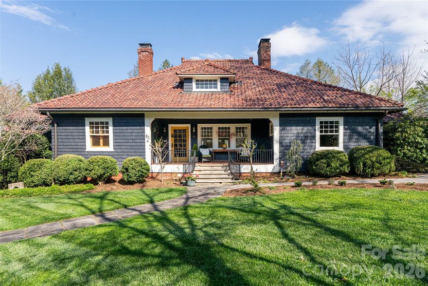 Timeless home filled with warmth, beauty, and character—a rare opportunity to own a piece of Asheville history. Originally the clubhouse for the Swannanoa Golf and Country Club (later the Asheville Country Club), designed by noted architect Richard Sharpe Smith and later relocated to its current setting. Located in the desirable Proximity Park/GPI neighborhood, less than one mile to the Omni Grove Park Inn and approx. 1.5 miles to downtown Asheville.

Single-level living with heart pine floors throughout and 4 bedrooms, all ensuite on the main level. Home features 4 fireplaces (2 wood-burning, all with gas starters), including a standout kitchen fireplace with rotisserie. Beautiful built-ins are found throughout, adding warmth, function, and historic character. Cedar shake exterior and clay tile roof complete the architectural appeal.

Extensive updates include new interior and exterior paint, renovated primary bath with heated floors, and a thoughtfully designed outdoor kitchen ideal for entertaining. Basement apartment with homestay permit and separate music studio/flex space provide added versatility. Additional features include wine cellar, sauna, and seamless indoor/outdoor flow with glass doors opening to inviting outdoor living spaces.

Set on 1.18 acres with usable park-like grounds—room for recreation (pickleball potential) and seasonal morel mushrooms. Walkable neighborhood with easy access to restaurants and shopping.