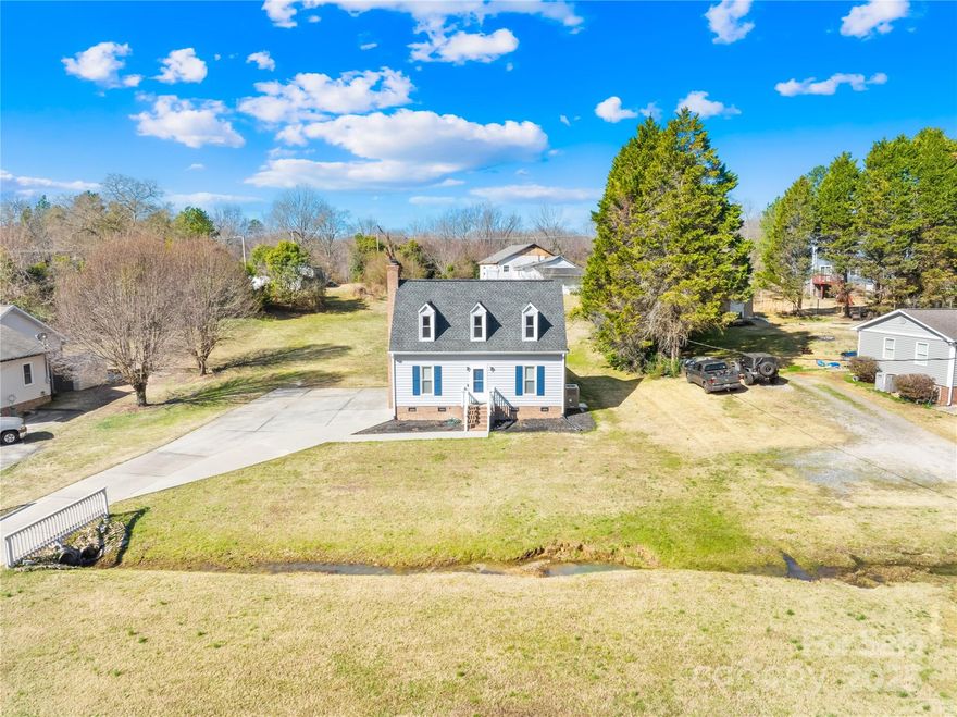 Looking at the taxes and concerned? Don't be! This house is currently taxed at an investment rate. Primary residence tax is much lower at $1700/year per York Co. Welcome to this charming 3-bedroom, 2-full-bath home on a spacious .51-acre lot. Built in 1990 and freshly painted inside and out, just minutes from downtown Rock Hill and I-77, commute & local amenities are a breeze. Main level features a primary bedroom with a large closet. The heart of the home is the cozy living room w/gas fireplace perfect for chilly evenings. Natural light throughout makes this home feel light and open. Upstairs are 2 bedrooms with large closets and another full bathroom. Storage is not an issue here. Step outside onto the covered back deck and enjoy a peaceful retreat with views of your expansive backyard – ideal for outdoor gatherings or simply unwinding in privacy.  With a functional layout, a prime location, and the potential to make this home your own, it’s an opportunity you won’t want to miss!