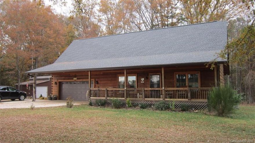 Wonderful Log Cabin nestled on 2 acres.  Features inviting rocking chair front porch.  Open Great Room with gas logs, kitchen with beautiful heart pine cabinets, center island and lots of storage.  Dining room with French doors to private covered porch overlooking wooded lot.  Master suite on main with walk in closet.  Two bedrooms and a office up.  Attached double garage plus det. garage and work area.  A unique find.