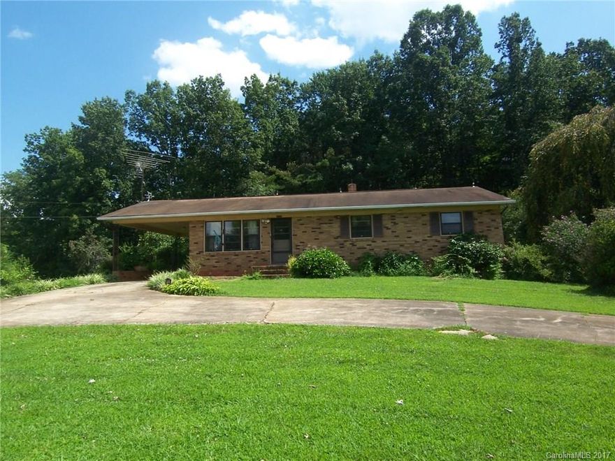 Brick 3 bedroom 1 bath ranch home situated on approximately 3.7 acres. Perfect for someone who enjoys country living. This home has beautiful mountain views! Lots of fruit trees and flowers. Several out buildings. Full unfinished basement. Circular concrete drive. Attached single carport, attached double carport, and a single car garage in the basement.