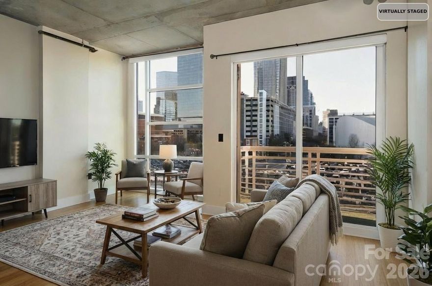 Discover the epitome of urban sophistication in this stunning modern industrial one-bedroom condo, perfectly positioned in the heart of Uptown Charlotte. Bathed in natural light, the residence boasts impressive floor-to-ceiling windows that frame breathtaking panoramic city views, showcasing Charlotte's iconic skyline from sunrise to sparkling night lights. The open-concept layout embraces a true modern industrial aesthetic, blending sleek contemporary finishes with raw, architectural character. Step out onto your private covered balcony, an ideal spot for morning coffee, evening relaxation, or simply soaking in the dynamic energy of Uptown life below. The home has been thoughtfully updated with fresh paint completed in 2026, creating a bright, move-in-ready atmosphere throughout. Perhaps most appealing is the seamless convenience: your reserved parking space is located on the same level as the condo in a secure, gated parking garage. Enjoy the rare ease of walking directly from your assigned spot to your front door—no steps, no elevator rides—making daily arrivals and departures incredibly effortless. Residents enjoy access to a fantastic community rooftop terrace, a premier amenity offering sweeping views, and the perfect setting for socializing, unwinding, or hosting friends against the backdrop of Charlotte's evolving skyline. Practical luxury continues with a Nest thermostat for effortless climate control and energy efficiency. The walk-in closet features smart built-in shelving for optimal organization, while the bathroom impresses with a beautiful tile shower that combines form and function. Nestled in one of the most desirable and convenient locations in Uptown, this condo places you steps from world-class dining, premier entertainment venues, professional sports arenas, cultural institutions, light rail access, and major employers. Don't miss this exceptional opportunity to own a slice of Uptown's dynamic energy—schedule your private showing today and experience the best of city living firsthand!