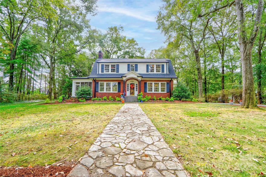 This stunning home blends historic character with modern comfort—and is recognized in the National Register of Historic Places, honoring its architectural significance and timeless appeal.  Original features include high ceilings, custom moldings, original doors, and gleaming hardwood floors. Spacious rooms, beautiful details, and custom light fixtures throughout add warmth and elegance.  The chef’s kitchen is a true showpiece—featuring granite countertops, stainless steel appliances including a Viking gas cooktop, custom cabinetry with backlighting, backsplash, and a walk-in pantry. Adjacent laundry/utility room includes sink and storage. French doors open to a multi-level deck that wraps around to a screened porch—perfect for relaxing or entertaining.  The home offers excellent flow and is truly built to entertain. And don’t miss the incredible basement speakeasy with a bar area—not included in heated square footage but ideal for unforgettable gatherings and personal enjoyment.  Located on a private, wooded, and beautifully landscaped 0.84 acre lot and just 1 mile from Uptown!  This is a must-see home full of charm, history, and lifestyle-enhancing features. Schedule your showing today!  New roof and gutters.  Electrical has been upgraded also.
