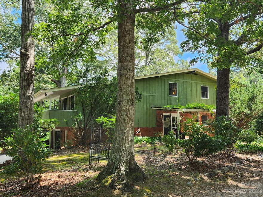 Perched on a knoll with private outdoor spaces, this cool mid-century home has so much to offer with a desired location! Savor time spent in the great room with soaring ceilings, abundant natural light, and covered deck to enjoy the outdoors. The functional floor plan offers a kitchen/dining/living area with wood stove, a large downstairs rec room with fireplace, and three spacious bedrooms upstairs. Owner updates over recent years include new mini-split heating and a/c units in 2022, new gutters, fresh flooring, kitchen cabinets, island, granite counters & extensive punch list updates. The sunny yard is perfect for pets, play, and your home gardens, and the driveway offers ample parking. This ideal location offers easy access to Asheville, all amenities off Hendersonville Rd, schools, recreation opportunities, restaurants, the airport, and more! Located in Buncombe County with no rental restrictions. Don't miss this great opportunity to love this charming Fairview home on a large lot!