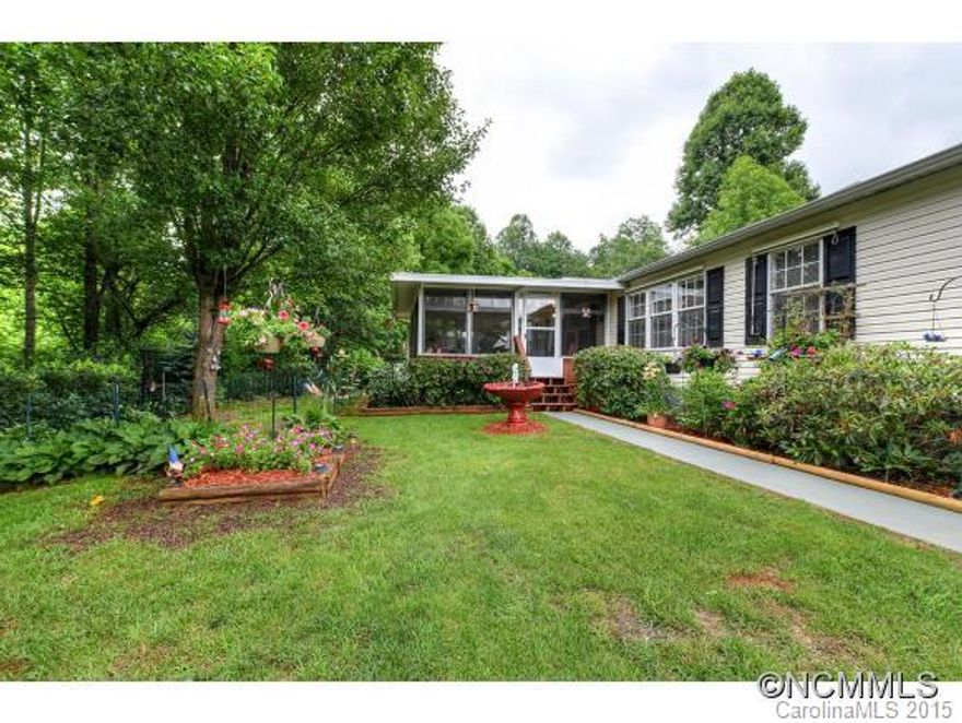 Enjoy the end of road privacy as you rock on your enclosed porch.  This beautifully landscaped home has been well maintained with special additions of a 2 car carport, 2 storage buildings with electricity, garden space, and 15'x 16 Florida room.  Extra care in the construction includes an open floor plan, kitchen island, fireplace, and split bedroom plan.  Great location near Dillsboro, Cherokee, WCU, SCC $2000 PAID FOR BUYERS' CLOSING COSTS