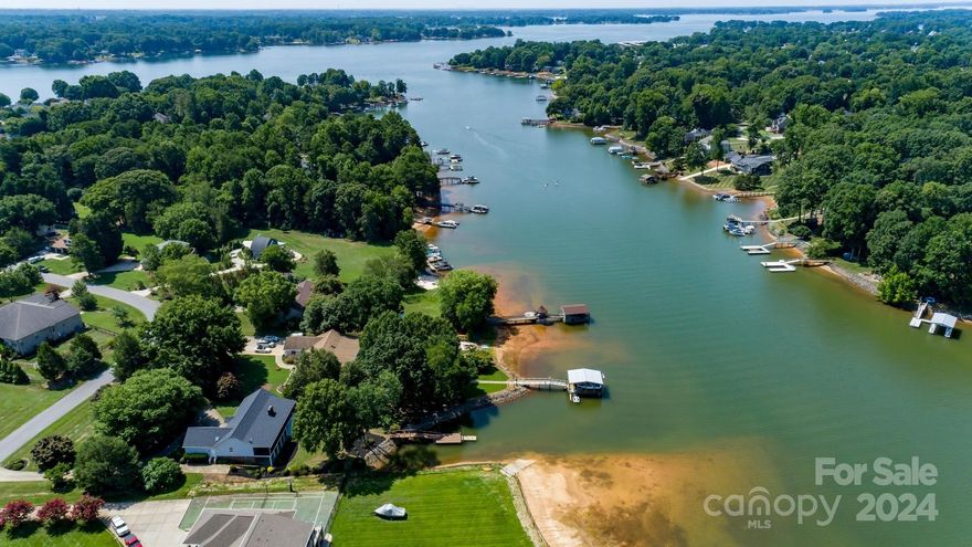 LIVE THE DREAM in this Lake Norman waterfront paradise w/SPECTACULAR SUNSET VIEWS! Outdoor entertainment is personified from one of the largest screened porches found on the lake. Relax and be dazzled by the dancing diamond show that appears on the sunlit water tips that outstretch the panoramic views. Amongst the great views, the large lot offers a deep cove for boating & water sports. Tiled daylight BSMT w/sep entrance and Kitchen offers endless opportunities & 2nd living potential. Many beautiful updates throughout home include: HW floors on majority of Main, fresh neutral paint, updated appliances/fixtures, new interior door hardware, newer roof, newer HVAC w/smart thermostat, new sleek black screened porch. Fruit trees & scenic landscaping wrap the large yard. Delight in the MAGNIF flower show each Spring from the multitude of stunning Azaleas & Camellias that blanket this property! VRBO potential. PRIME LOCATION. Virtual staging shown in several pics. NO HOA/COUNTY TAX