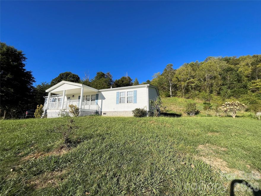 Beautiful and Affordable! Come enjoy peace of mind in this lovely home on 2.33 acres! Built to last with many recent updates, this home will fulfill all of your wants and needs! Looking for privacy? Open sunny spaces? Gardening areas? Views? Convenience? An additional building site? It's all here! This spacious home with a coveted split bedroom plan has a new 2025 HVAC, newer appliances, newer LVP floors, and a newer lifetime metal roof! Walk-in closets, mud room, and pantry provide so much storage space--while the open floor plan allows for pleasant gatherings with room for everyone! There's really nothing left to do except settle in and soak up the the views from your deck or cuddle up around the wood burning fireplace and enjoy life! This home sits on a sunny ridge that's only five minutes from just about everything--shopping, dining, schools, and the fun festivities of downtown Marshall--all while being just 15 minutes to Weaverville and 22 minutes to downtown Asheville. The land is rolling with many flat areas for building another home (one single home or one duplex allowed per zoning), gardening, workshops--so many possibilities. Plenty of easy parking, too! Marshall is the new hot spot! Claim your space affordably while you can!