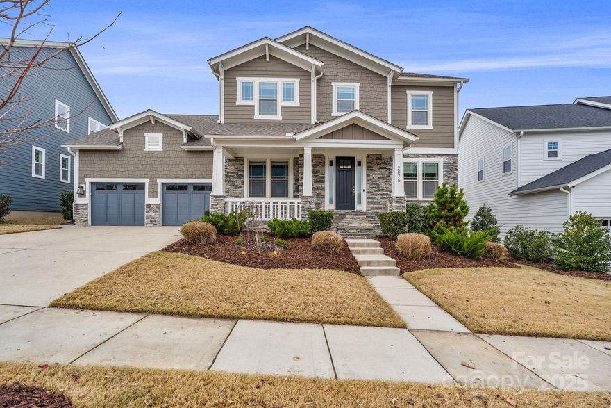 Welcome to 2075 Masons Bend Drive—a home built in 2021 in the Masons Bend community. Step inside to a show-stopping, modern kitchen featuring high-end appliances including a 6-burner gas cooktop and stacked wall oven and microwave, a waterfall quartz island, floating wood shelving, an expansive walk-in pantry, built in bar and a butler’s pantry—perfect for entertaining and everyday living. A main-level guest bedroom adds flexibility for visitors or multigenerational living. The kitchen flows into the living room showcasing coffered ceilings, a sleek linear gas fireplace, custom electric shades with remote, and access to the covered porch. An office nook with a built-in desk provides an ideal work-from-home setup. Upstairs, the primary suite offers a tray ceiling and an impressive walk-in closet, while the spa-like ensuite features a frameless glass shower, dual vanities with white quartz countertops, and a standalone soaking tub. Two additional bedrooms share a Jack-and-Jill bath, and the upper level is completed by a bonus room, an additional full bath, and a laundry room with a sink and extra storage. Outside, enjoy a fully fenced backyard and covered Trex deck, ideal for relaxing or hosting. Along the side of the home, you’ll also find planters ready for your green thumb. The oversized two-car garage includes convenient overhead storage shelving. Masons Bend residents enjoy a variety of amenities including a pool, splash pad, playground, fire pit, clubhouse, and fitness center, along with scenic trails and direct Catawba River access with a kayak/canoe launch. All of this in a prime location just minutes from shopping, dining, and Uptown Charlotte.