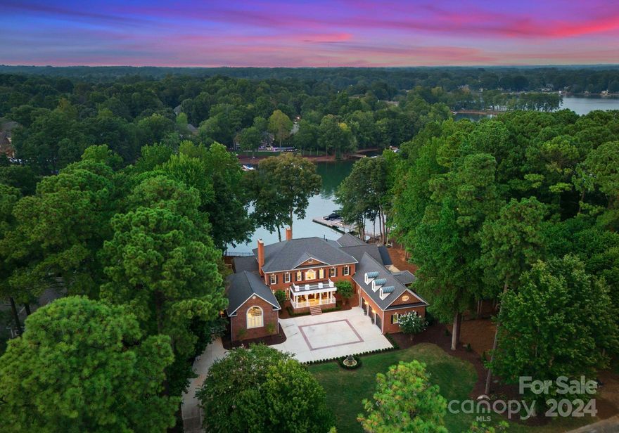 Nestled on 245 feet of shoreline on Lake Norman, this magnificent home in the village of The Point is the epitome of southern lake living! With 10,700 square feet of living on three levels, this estate just underwent an impressive full interior/exterior renovation with no detail spared. Encompassing 5 bedrooms & 8 baths, the brand-new interior highlights a stately foyer, formal dining room, expansive living spaces, private office & gorgeous new primary suite  on the main level. Upstairs you’ll find 3 private bedrooms & bathrooms + a large bonus room perfect for guests. Take the brand new elevator to the lower level for the best of lake entertaining with a brand new bar plus kitchen scullery, state of the art golf simulator, private bedroom & 2 bathrooms. Step outside to a true outdoor oasis - with a brand new saltwater pool/spa & a private dock. Please see the special features sheet highlighting the complete renovation list. Prepare to be amazed by this complete transformation!