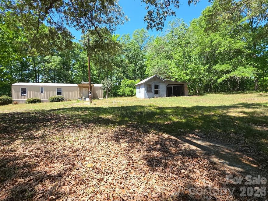Transform this 1.5 acre lot with large mature shade trees into your own slice of Pageland, SC!  It is located in a well established rural area, with plenty of paved road frontage. The parcel is located within a short distance of Hwy 151 South, that affords easy access to area amenities. With some updates, the singe wide manufactured home with adjacent storage/shed, can become a cozy place to live.