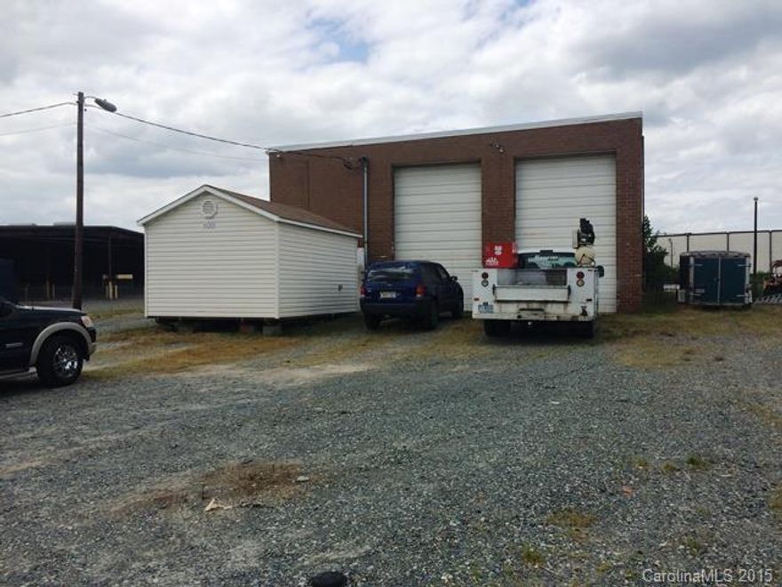 2400 SF brick building.  Two bays with drive thru doors 18’ high.  One 12 high roll-up door.   Two offices.  Property is fenced and is paved and graveled.  Almost 1 acre of land.  Great for automobile shop or office warehouse use.  New roof in April 2014.