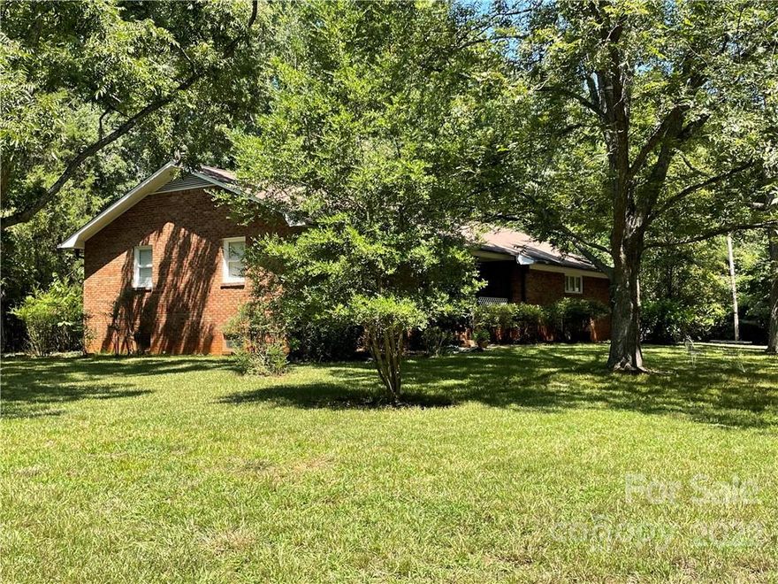 ONLY 2.98 ACRES left to sell!  1 acre has a water view toward the northeast portion!  The remaining 1.98 acres includes a full brick ranch with a full basement that offers tons of natural lighting, sitting on a large flat secluded lot in a quiet community with no HOA! Central air and heat pump, kitchen appliances, new flooring, fresh interior & exterior paint, new commodes, and gutter guard system with a lifetime guarantee; all replaced 3 years ago!
The private third bedroom does not have a typical closet but has an entire wall of shelves that offer ample amount of storage space.  There is an additional fireplace in the basement and a utility house adjacent to the garage for extra storage.  So much potential and located so close to Lake Norman!  This property is a must see!