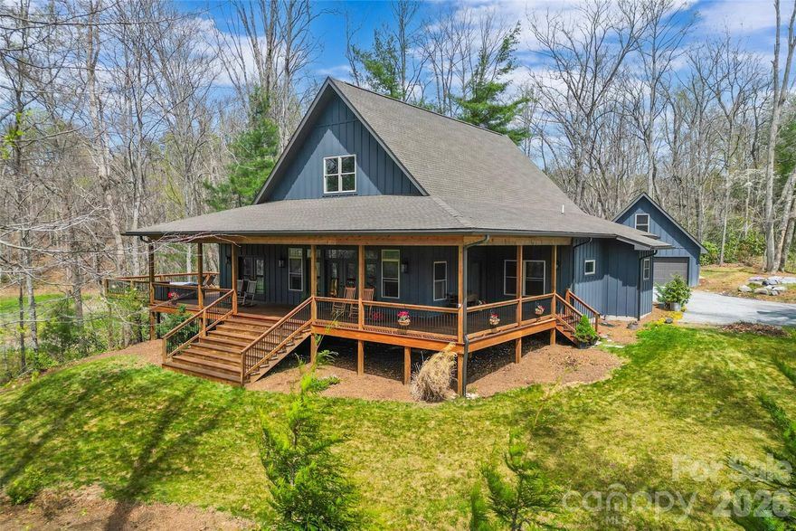 Stunning custom-built modern farmhouse perfectly positioned in beautiful Cane Creek Valley with its own pond! This meticulously maintained home brings together privacy, craftsmanship, and a whole lot of lifestyle on 2.6 acres. Think peaceful mornings, year-round views of Bearwallow Mountain, and the perfect balance of “away from it all” while still being just minutes to everything you need.

Inside, the home was made for easy, everyday living with a light-filled open floor plan, soaring 27-foot vaulted ceilings, and oversized windows and French doors that let the sunshine pour in. White oak floors, modern fixtures, and recessed lighting keep everything feeling fresh, clean, and effortlessly elevated.

The kitchen is a true showstopper and gathering place, anchored by a custom black walnut island that’s ready for everything from casual breakfasts to full-on entertaining. Soapstone countertops, twin pantries with farmhouse sliding doors, and a high-end appliance suite—including a Hallman gas range, LG refrigerator, GE oven, and Bosch dishwasher—make it as functional as it is beautiful. Just beyond, the cozy living area with a gas fireplace and custom mantel is the perfect place to unwind.

The split-bedroom layout offers comfort and privacy, with a dreamy primary suite that feels like its own retreat—filled with natural light, featuring dual walk-in closets, and French doors that open right onto the porch. The spa-like en-suite invites you to relax with a soaking tub, glass shower with pebble-honed tile, double vanity, and private water closet. The Jack-and-Jill secondary bath is equally well-designed with a modern double vanity, walk-in shower, and its own separate toilet space.

You’ll also love the spacious main-level mudroom with utility sink, whole-house wiring for internet and security, and a dual-zoned heat pump for year-round comfort.

Upstairs, a bright loft offers endless flexibility—home office, wellness space, or guest retreat—while the detached two-car garage with unfinished, plumbed flex space above is ready for whatever you dream up next.

Outside is where this property really shines. Expansive covered porches with tongue-and-groove ceilings and recessed lighting set the stage for slow mornings and long evenings, while the deck with sleek metal railing overlooks the spring-fed pond and peaceful natural surroundings. Thoughtful landscaping and hardscaping, mature plantings, and a charming pea gravel drive complete the setting, along with oversized gutters and downspouts for lasting quality.

Beautiful, functional, and full of possibility—this is mountain living at its best. Short-term rentals are allowed.