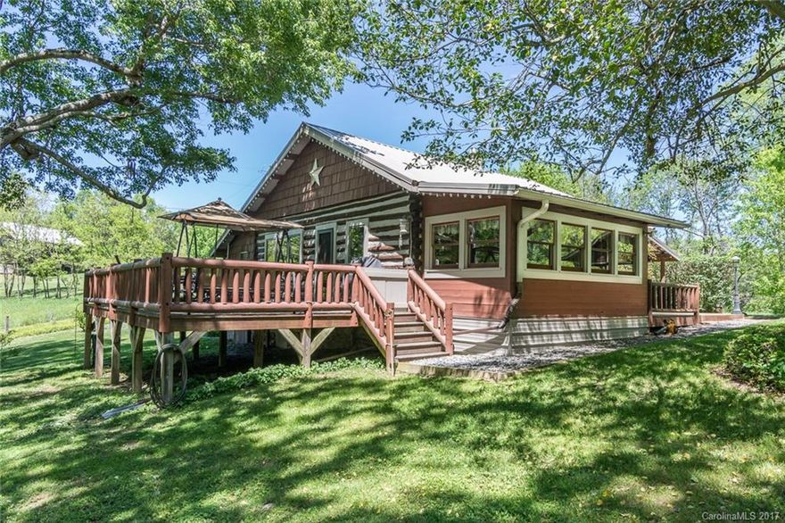 Enchanting, fairyland property on ten rolling acres close to town. Property includes charming renovated 1900's log cabin, separate guest camp cottage, lovely streams and spring with bridges and tree swing, massive tree fort, cozy fire pit, and numerous maintained hiking trails with wildflowers galore! Easy-build, big view homesite, too! Come see this magical property! A perfect homestead, fun family get-away, or great vacation rental complex! Only 6 mins to hip Main St; 35 mins to Asheville!