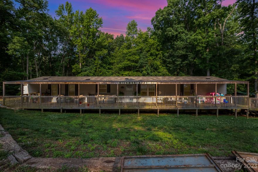 Country living with a plus. This lovely property has everything and then some. The kitchen is very ample and attractive. The dark cabinets and countertops make a wonderful contrast with the lighter color floors. The entire kitchen and dining room have Laminated Vinyl Floors—the large living room with ceiling fans and carpet. The two bathrooms have a bathtub. Some of my favorite features are the large front port that wraps around the entire front of the property and the backyard is an Oasis! The above-ground pool, playground, and deck will make your country living an experience. You will not want to leave home. In addition, the property is entirely surrounded by trees which gives you additional seclusion and privacy.