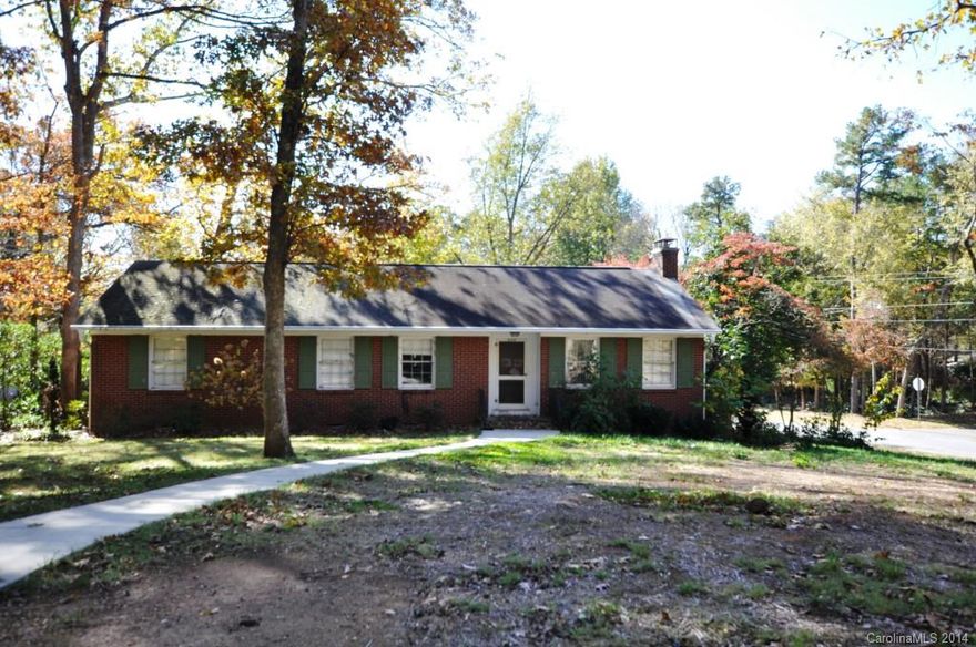 Charming brick 1950's home on a corner lot. Hardwood floors throughout most of the house. Gas log fireplace in Great Room. Screened porch and large deck on the back. One car garage with entry in the back. We are told there is a generator as well. All appliances remain, including the washer/dryer combo unit in the kitchen. This is an estate sale, being sold as is. Lovely mature trees and mature landscaping on a corner lot, sized .51 acres.