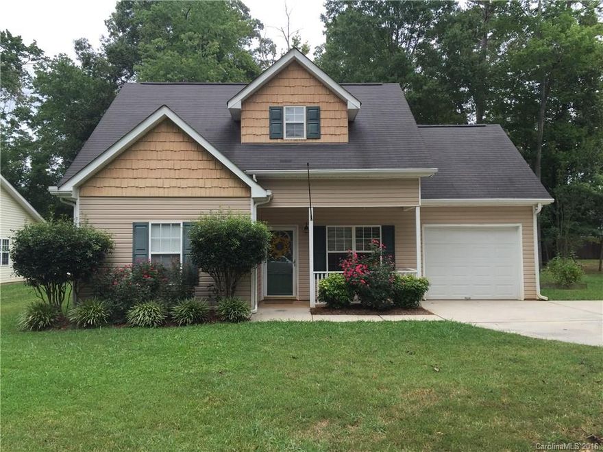 Two Story home in Indian Trail with master on first floor. 3 bedrooms, 2 baths, updated kitchen, laminate wood floors on first level, fireplace and attached one car garage.