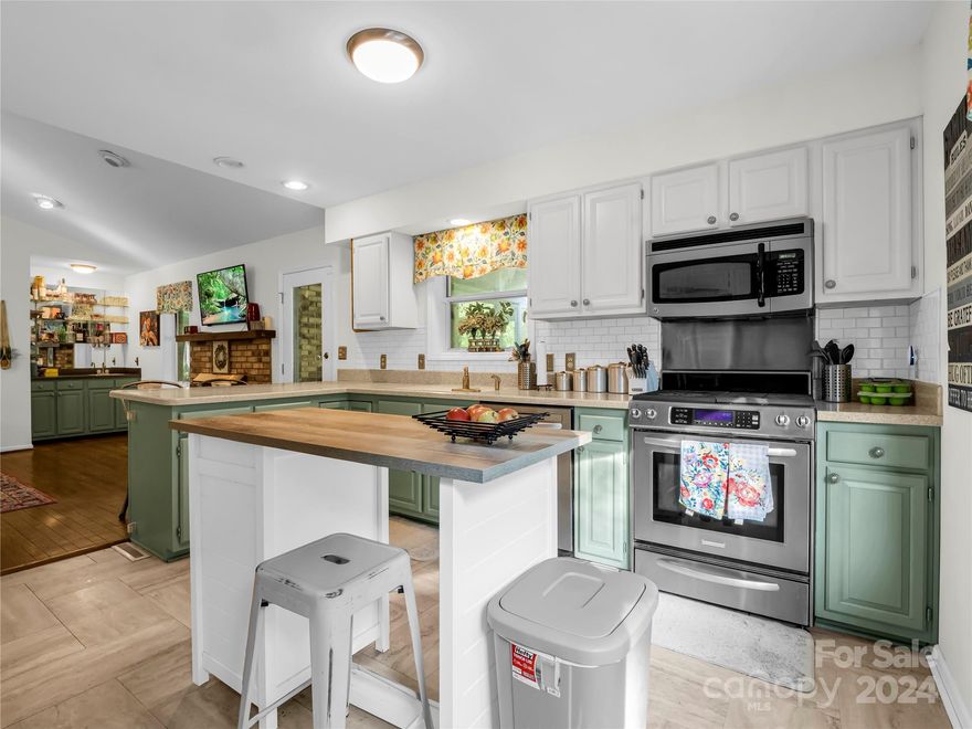 Nestled in a quiet neighborhood, 26 Chariot Court offers the perfect blend of mountain living and comfort. This beautiful home is surrounded by mature trees, providing a peaceful and private setting. The property features a new roof, ensuring peace of mind for years to come. Inside, you’ll find an updated kitchen with modern appliances and finishes, hardwood floors, and smooth, vaulted ceilings that create an open and airy feel. The wet bar adds an elegant touch for entertaining while the bay windows flood the home with light. The primary bedroom has two spacious closets for ample storage. A tiled sunroom invites you to soak in natural light, while the cozy fireplace in the living room provides warmth on chilly evenings. The walkout basement is partially finished, offering additional living space and a two-car garage with plenty of storage options. This home is a true gem, offering comfort, style, and the tranquility of mountain living, all within close proximity to Hendersonville.