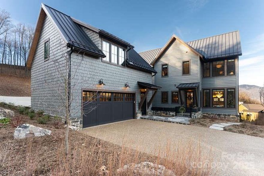 Effortless Mountain Living

Set within the private gates of Balsam Mountain Preserve, this refined mountain residence is prepared for immediate enjoyment, pairing timeless architecture with a thoughtfully low-maintenance lifestyle. Completed less than one year ago, this offering represents the first resale in the Village and the largest of the Village home models, The Willow—an uncommon opportunity combining scale, design, and ease within this sought-after enclave.

The interiors embody modern designer Appalachian luxury, expressed through a rich, nature-inspired palette and carefully curated finishes. Wide-plank engineered oak hardwood floors anchor the home, while expansive windows frame mountain views and introduce an abundance of natural light. Five well-appointed bedrooms, each with a private en-suite marble bath, provide comfort and privacy for both everyday living and hosting.

The kitchen is elegantly composed, centered around a marble island and custom cabinetry designed for both beauty and discretion. Premium appliances include a Wolf induction range, Sub-Zero refrigeration, Cove dishwasher, Marvel wine refrigerator, and Whirlpool laundry. A concealed pantry supports uncluttered living, while bespoke Roman shades, tailored drapery, designer lighting, curated wall coverings, and refined textiles create a cohesive interior experience throughout.

Living areas are grounded by a gas stone fireplace with custom built-ins, offering warmth and architectural presence. The primary suite serves as a private retreat, featuring heated marble floors, a steam shower in the primary bath, custom glass enclosures, and expansive custom-designed closets. All bathrooms are finished in marble with designer tilework and glass enclosures, reinforcing a sense of understated luxury.

Outdoor living unfolds across a generous mountain-facing deck, thoughtfully appointed for year-round enjoyment and enhanced by an outdoor kitchen with grill, rotisserie, and pizza oven. Infrared heaters extend seasonal use, while a fenced front courtyard provides a discreet and practical space for pets.

A rare feature within the Village, the detached two-car garage includes epoxy flooring, dual high-capacity his-and-hers electric vehicle chargers, and a substantial studio above with kitchenette and full bath—well suited for guests, extended family, or a private workspace. Additional considerations include a whole-house generator, expanded propane capacity, encapsulated crawl space with climate-controlled storage, integrated CAT6 wiring, fiber connectivity to the property, a fully integrated whole-house network, plumbing in place for an upstairs laundry, and custom built-ins throughout.

This residence offers a composed balance of design, comfort, and effortless ownership within one of Western North Carolina’s most distinguished private communities.