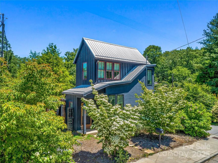 Discover this beautifully designed home in the heart of West Asheville, steps from vibrant Haywood Road. Thoughtfully crafted with artistic attention to detail, this one-of-a-kind residence blends modern comfort with character-rich, reclaimed materials. Main level features polished concrete floors and an open layout that connects living/dining/kitchen. The pantry—adorned with a salvaged screen door from New Orleans—offers convenient storage. The kitchen is highlighted by locally salvaged materials, including an enameled drainboard sink and vintage base cabinets. Upstairs, you'll find a charming, light-filled bedroom with warm cork flooring and reclaimed closet doors, plus a full bathroom with a subway tile shower. Step outside to enjoy a fully fenced backyard. Prime location, unique craftsmanship, and artistic flair, this home offers them all—in one of Asheville’s most desirable neighborhoods.