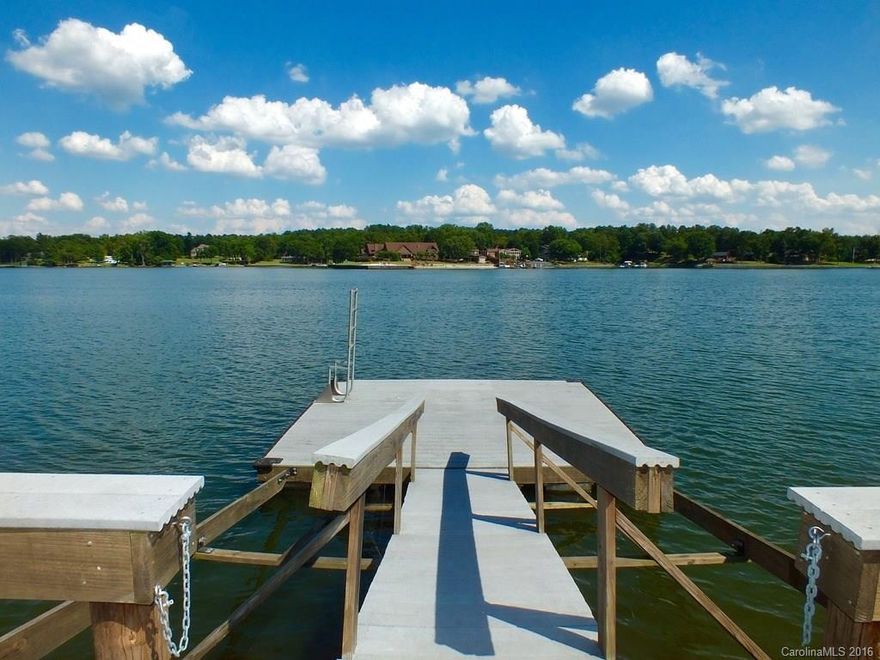 Amazing views on over one acre of land. 180 degree panoramic view of Little Allison on Lake Wylie. Vaulted ceiling in main living area.  Home has beautiful wood and beams throughout.    The land and lake views are spectacular!!!!  Lake view from every room. 2 Mstr suites on opposite ends provide utmost privacy. The stationary/floating dock &  boathouse are grandfathered in.  Home needs some updating which is reflected in price.  A must see!!