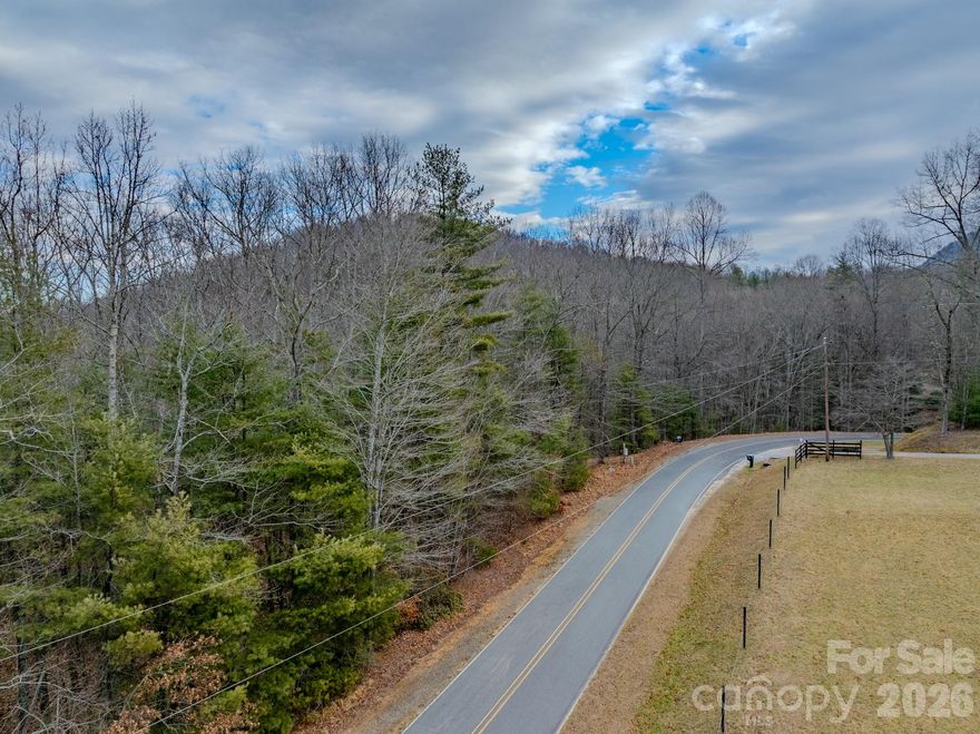 Offering 5.01 acres of private mountain land with direct access off state-maintained Old CCC Road in western Henderson County. Unlike many steep tracts in the area, this property features approximately 2.5 acres of gently sloping, highly usable terrain, making it exceptionally well-suited for building.

The land is beautifully composed of mature hardwoods, mountain laurel, and rhododendron, and has been recently underbrushed and well-maintained, allowing the natural beauty to shine while making the property easy to walk and envision. Located within the quiet community of Settlers Ridge, the parcel offers complete privacy and seclusion, with no neighboring homes visible from the site.

While the property is part of a planned community, restrictions are minimal, the HOA fee is just $100 per year, and the building approval process is straightforward—refreshingly unlike a typical HOA experience. Utilities are within reach, with a Duke Energy cabinet already on-site and AT&T wired internet nearby. As is common for the area, a private well and septic system will be required.

The location is ideal for those who value both privacy and access: 3.8 miles from Jeter Mountain Farm, roughly halfway between Hendersonville and Brevard, and a dream setting for outdoor enthusiasts. The property sits approximately 1,000 feet from Holmes Educational State Forest, is 4 minutes from DuPont State Forest, and is just 17 minutes from Pisgah National Forest.

If you’re seeking a rare combination of usability, privacy, natural beauty, and location, this mountain parcel deserves a closer look. Contact the listing agent today to schedule a showing or learn more.