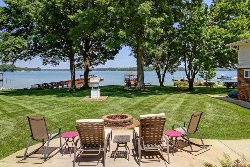 The lake is the star inside and out of this well maintained home. At the end of a Peninsula, you feel as if you are on vacation year round! Home has been completely remodeled (2008) including a new roof & so much more. Care was taken to make sure that the lake played center stage, with huge windows in the great room, a river rock fireplace surround, an inviting rear patio, firepit, cvred dock w/ seating, lots of charm! A rare natural sand beach makes lake access easy! Outbuilding is a bonus!