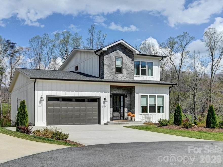 Welcome to easy mountain living at 18 Sagewood Drive. Tucked at the end of a cul-de-sac in Stoneridge at Hayes Mountain, this 2022-built home offers a quiet setting in Candler with Asheville just a short drive away. Shopping, dining, entertainment, and everyday essentials are all within easy reach, giving you the perfect balance of privacy and convenience. Inside, the bright open-concept main level is designed for comfortable daily living and effortless entertaining. The living room, dining area, and kitchen flow seamlessly together, while large windows fill the space with natural light and frame seasonal mountain views. The kitchen features generous cabinetry and ample counter space, making meal prep simple while keeping everyone connected. The spacious primary suite on the main level offers a private retreat with a walk-in closet and en-suite bath. Upstairs bedrooms are well-sized and flexible for guests, hobbies, or additional living space. Laundry connections on both levels add everyday convenience, while an office and separate study area provide valuable flexibility for remote work, reading, or creative pursuits. Step outside to the covered rear porch and enjoy the peaceful neighborhood setting. The manageable lot offers outdoor enjoyment without the burden of constant upkeep. 18 Sagewood Drive combines modern comfort, low-maintenance living, and a mountain setting while remaining close to the vibrant restaurants, shopping, entertainment, and amenities of Asheville. If you’ve been looking for a peaceful place to call home near the city, this is the one. Schedule your showing today!