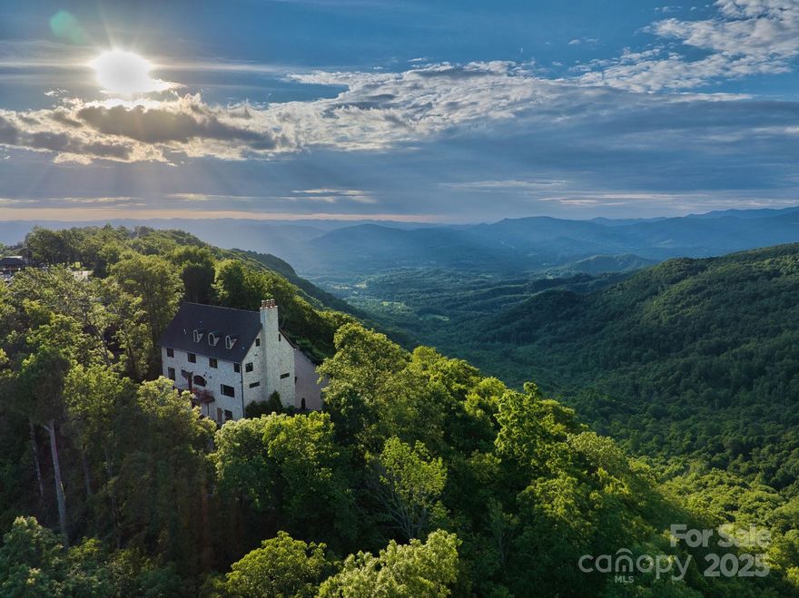 Breathtaking views surround this beautiful home with a European aesthetic at 3,800ft on Bearwallow Mountain in Grand Highlands. Stunning Turkish marble floors, a grand staircase, and hand carved Indian doors open up to a formal dining room, setting the tone of this exquisite home as you step inside. Antique chandeliers light the barrel vaulted gallery leading into an expansive living room with N/S views. The designer kitchen with butler’s pantry features a collection of beautiful cabinetry, Herbeau farmhouse sink, a cozy gas fireplace, walk-in pantry, and custom dutch door to the back deck. Upstairs, the 2nd and 3rd levels feature two primary bedrooms, a Study w/wet bar, office, and spacious top level with full bath and additional 294sqft bonus space. Designed to evoke old world charm unique to many newer build homes, 278 Snow Ridge Drive sets itself apart. Enjoy the social lifestyle of a gated community in a panoramic mountain view setting, while being situated on a private lot.