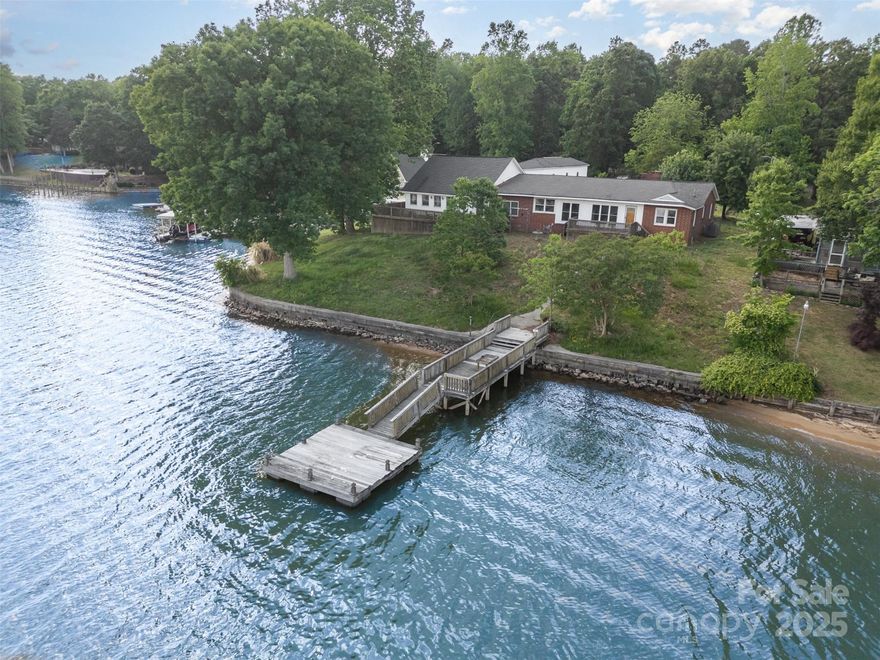 Rare opportunity on High Rock Lake! This waterfront property offers stunning lake views, with tons of potential for investors, flippers, or buyers ready to make it their own. The home features a massive entertainment room/ballroom with a built-in stage—ideal for hosting or reimagining as a great room. A 4-bay garage includes a workshop area and unfinished space above, perfect for a guest suite or rental unit. While the home needs some TLC and updating, the solid structure, unique layout, and unbeatable location make this a smart investment with endless possibilities.