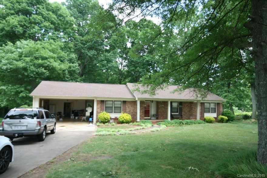 Excellent brick with double garage. Hardwoods in foyer and den with fireplace. New Corian counters in kitchen.  Large partially covered deck 24x12. Above ground pool with decking. Wired workshop 16x20. 2 beautiful wooded acres. Park like setting in back. Fenced back yard. A rare find. This won't last long.