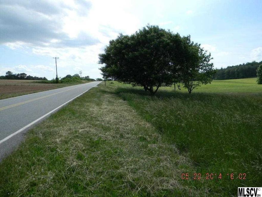 Nice home site with lots of options.  This property is located in a beautiful area with surrounding mountain views, farm land and is very close to the South Yadkin River.  Property has good road frontage with a small gravel drive in to the property and a small outbuilding. This property used to have a single wide home on it so it has had some improvements.  Seller has septic permit (see associated documents link) and a copy of prior survey to show buyer. There are three pins. See Associated Docs link to print out aerial, survey and septic permit. Energy United Water says public water is at the street.