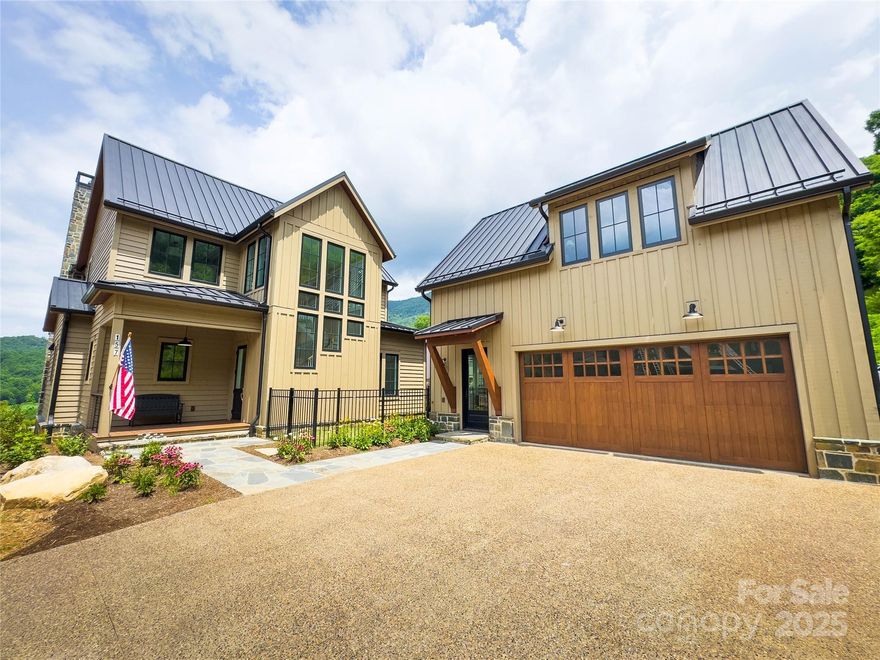 Nestled in the serene Balsam Mountains of Western North Carolina, this exquisite newly constructed residence offers sweeping views of both the Arnold Palmer–designed golf course and majestic mountain landscapes.
The main home features 3 spacious bedrooms and 3½ luxurious bathrooms.  The gourmet chef’s kitchen is designed for culinary excellence, featuring luxury Wolf and Sub-Zero appliances, quartz countertops, and custom cabinetry. The open concept layout seamlessly connects the kitchen to the living and dining areas, perfect for entertaining. The covered outdoor living space is equipped with its own kitchen and grill, ideal for al fresco dining and gatherings. There is also a beautiful bedroom with a private bath, located above the detached 2-car garage, which would be perfect for guests, or an office.