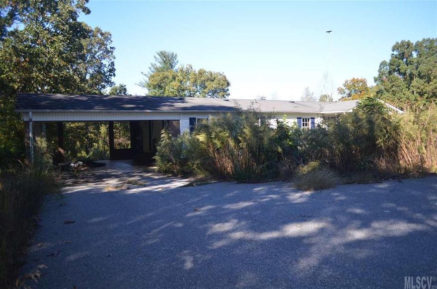 ** offer has been accepted on this property** Corporate owned Double wide with Carport attached sits on 3 acres.  Nice laminate flooring, split bedroom plan, fireplace, very private.  Single wide on the front of the property. Not financeable,  Furnace part inside is missing.