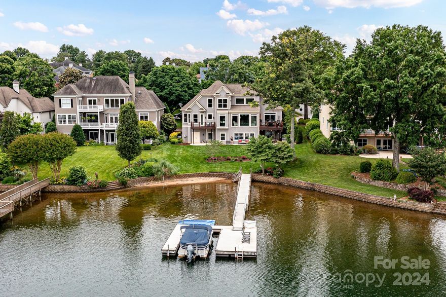 Experience resort-style living in this impeccably renovated waterfront home nestled within the prestigious waterfront golf community of The Peninsula. Offering breathtaking vistas of the lake and situated in a tranquil no wake zone just off the main channel, this home epitomizes luxury lakeside living. Step inside to discover a seamlessly designed interior boasting panoramic lake views and showcasing the meticulous attention to detail. Featuring two luxurious primary en suites on the main level, a gourmet chef's kitchen adorned with custom cabinetry, quartz countertops, a leathered granite island, and high-end appliances, this home is an entertainer's dream. Ascend to the upper level to find a versatile loft space. The lake level offers additional exceptional living space and access to the lake, while an unfinished 1100 square foot space presents endless possibilities. Delight in the convenience of your private dock. Move right in and savor the tranquility and luxury of lakeside living