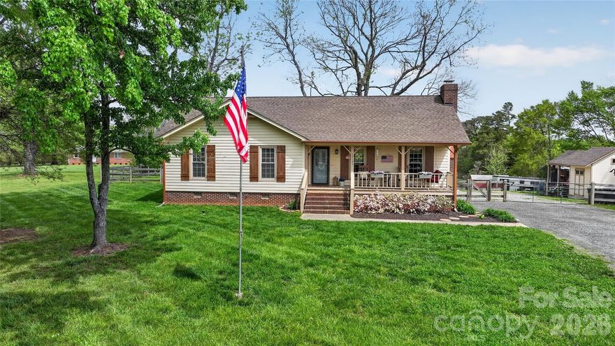 Redwood Cedar Ranch home on approx. 2 acres in Huntersville! Escape to your private two-acre sanctuary in this stunning Redwood Cedar Ranch Farmhouse. Located in Huntersville with the added benefit of no city taxes, this home offers a peaceful retreat from the moment you step onto the charming rocking chair front porch. The heart of the home is a beautifully updated kitchen featuring elegant quartz countertops, a casual breakfast bar, and a large single-bowl farmhouse sink overlooking the pasture & horse barn. It comes fully equipped with stainless steel appliances, including Profile electric cooktop, built-in microwave wall oven, dishwasher, and a refrigerator that conveys with the sale. The  dedicated laundry room w/cabinets for storage conveniently located just off the kitchen. The open-concept layout flows seamlessly from the dining area into a majestic living space anchored by a stone wood-burning fireplace, Pergo planking perfect for cozy evenings. When it’s time to retire, the spacious primary bedroom offers a spa-like escape with a completely renovated bathroom featuring an oversized tiled shower, modern lighting, and premium black fixtures. Your living space extends outdoors into a massive 16x30 covered screened porch w/outdoor carpeting and two light/ceiling fans & 226 sq. ft. of open deck area. Whether you are hosting a summer gathering or enjoying a quiet morning coffee, this area provides the perfect vantage point to take in your sprawling property. Five-stall horse barn with a tack room, loft storage and fenced pasture, while hobbyists will love the large storage shed w/lighting and dedicated gardening shed with an overhang. Well holding tank enclosed in shed area. With a new HVAC-Heat Pump installed in 2023 and distinctive copper-plated gutters and downspouts, this home is as well-maintained as it is beautiful. Experience the perfect blend of rustic character and modern convenience in a location that feels a world away.
